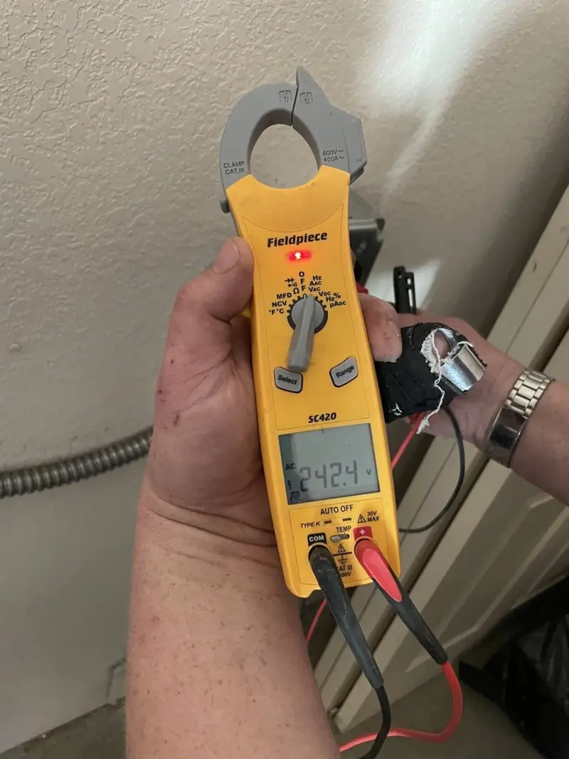Voltage testing with clamp meter during Electrical Installation Services in Clinton